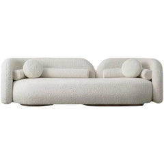 "Modern Curved Off-White Bouclé Sofa with Round Accent Pillows"